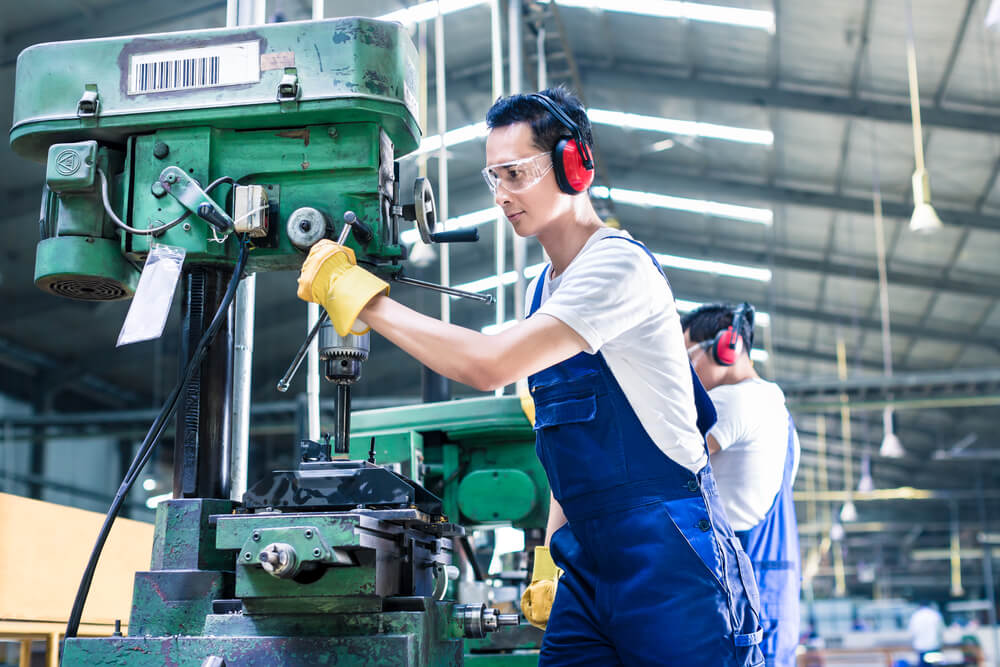 worker-in-production-plant-drilling-at-machine-on-the-factory-floor